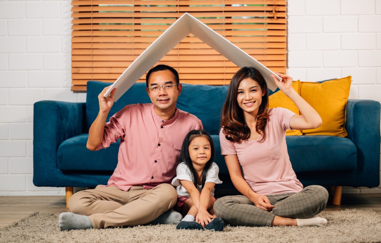happy-family-holding-symbolic-cardboard-roof-of-life-insurance.jpg